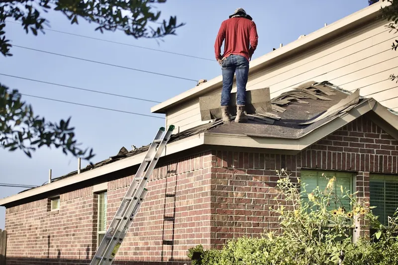 Professional roofer working on a residential roof in Greystone